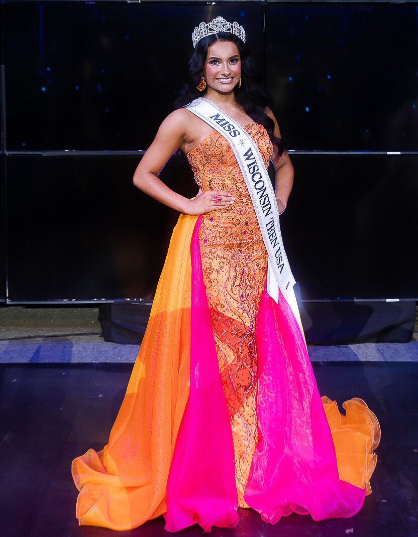 Leia Rios on stage in pink gown with crown and sash